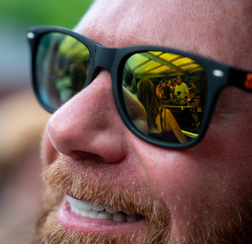 Rave-goer, Rebūke x Patrick Topping in sunglass reflection