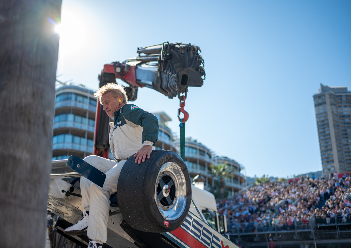 Steve Brooks crashes his Essex livery Lotus 81 during practice at the Monaco Classic, sitting on the front tire to balance the car to get it onto the flatbed lorry, Monaco